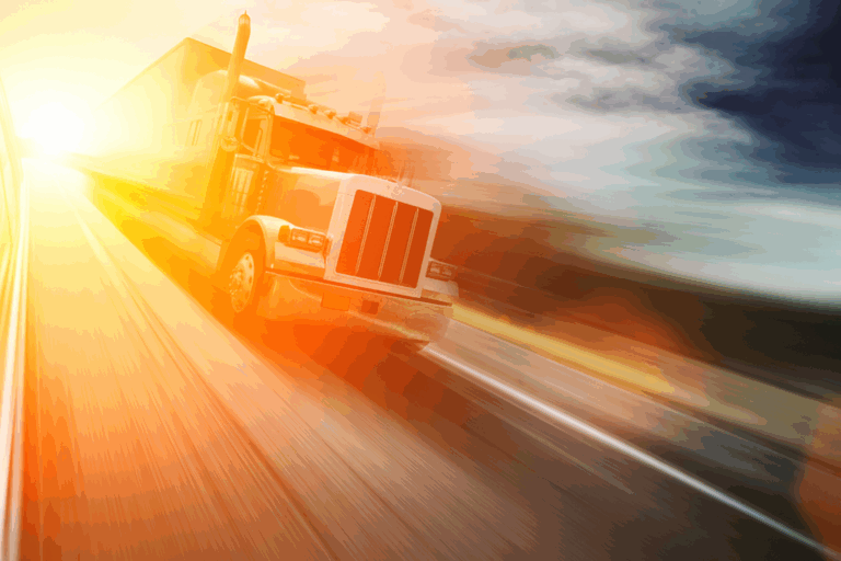 A semi-truck driving toward the sunrise on an open highway, symbolizing recovery and forward progress in trucking compliance.