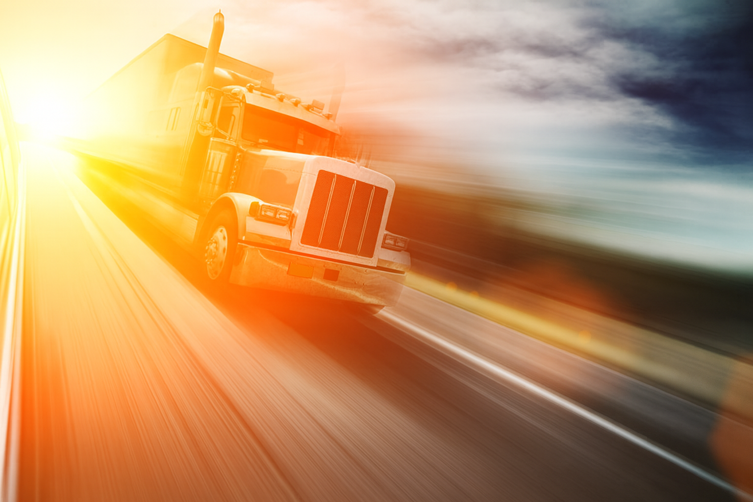A semi-truck driving toward the sunrise on an open highway, symbolizing recovery and forward progress in trucking compliance.