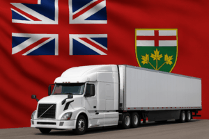 White semi-truck and trailer in front of the Ontario provincial flag, symbolizing trucking compliance and CVOR audit preparation in Ontario.